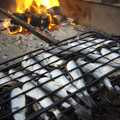 Herrings are readied for cooking on an open fire