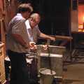 A couple of dudes demonstrate the art of glassmaking