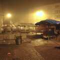 Deserted market stalls lurk in the fog
