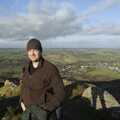 Nosher with his Christmas beanie hat, on top of Meldon Hill. Chagford is in the background.