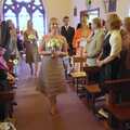 Bridesmaids walk up the aisle