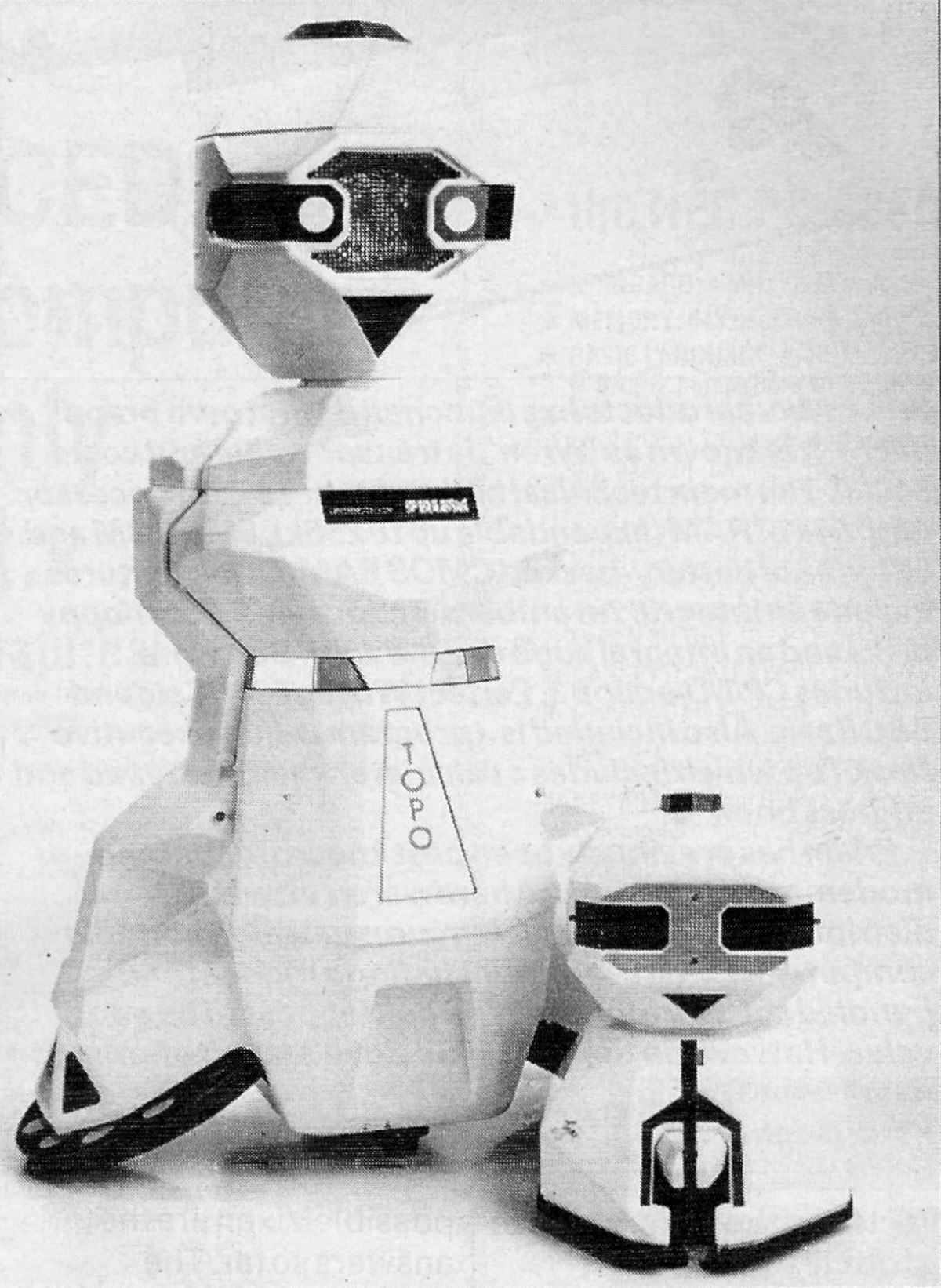 Androbot's Topo and FRED robots, displaying Prism badges. From Personal Computer World, March 1984