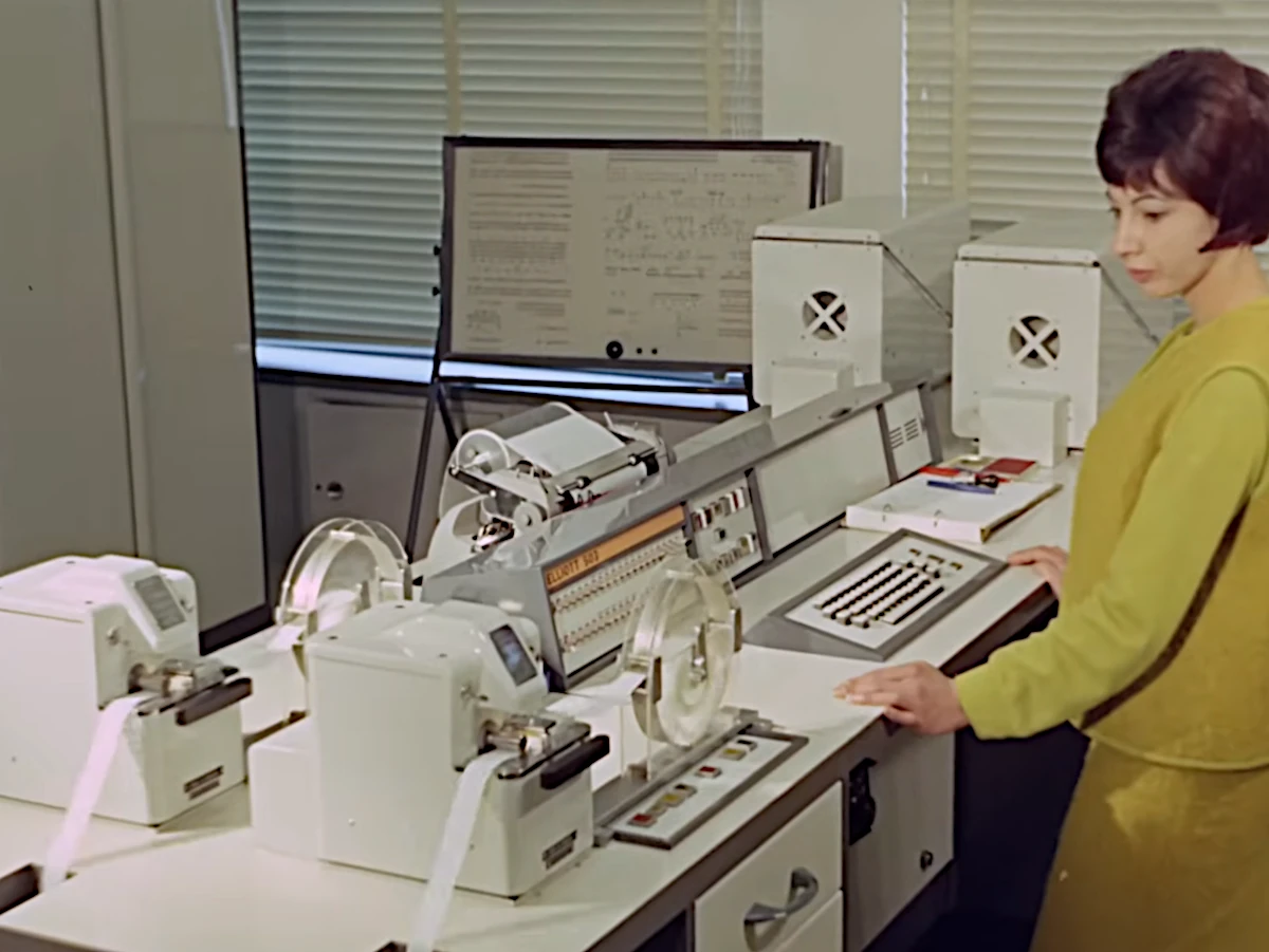 Paper-tape readers and the input terminal of an Elliott 503 in action in an office in Hobart, Tasmania in 1966. From a film published by the National Film and Sound Archive of Australia: https://youtu.be/rh5cqhLerEg?si=fjge9tf7ePMG-rsj
