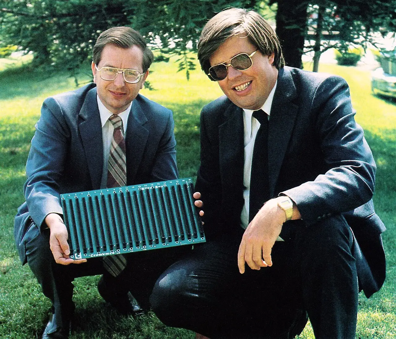 Harry Garland and Roger Melen - the founders of Cromemco - pictured holding an S-100 backplane. Originally known as the Altair Bus, Garland and Melen coined the name S-100, or Standard 100 after its 100-pin edge connectors, to avoid referring to a competitor's product. Image via Wikimedia, CC BY-SA 3.0. https://commons.wikimedia.org/wiki/File:Harry_Garland_and_Roger_Melen,_co-founders_of_Cromemco_(1981).jpg Harry Garland and Roger Melen - the founders of Cromemco - pictured holding an S-100 backplane. Originally known as the Altair Bus, Garland and Melen coined the name S-100, or Standard 100 after its 100-pin edge connectors, to avoid referring to a competitor's product. Image via Wikimedia, CC BY-SA 3.0. https://commons.wikimedia.org/wiki/File:Harry_Garland_and_Roger_Melen,_co-founders_of_Cromemco_(1981).jpg