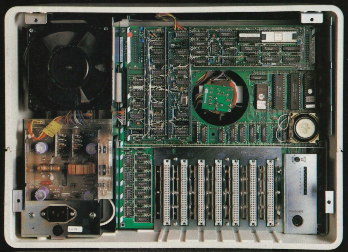 Inside a pre-production Decision Mate V, featuring some ad-hoc wire patching on the main PCB