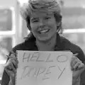 Jo holds up a 'hello Dopey' sign, Learning Black-and-White Photography, Brockenhurst College, Hampshire - 10th March 1985