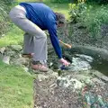 Andy picks a croquet ball out of the pond, Nosher's 18th Birthday, Barton on Sea, Hampshire - 26th May 1985