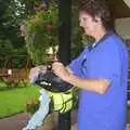 Jill wipes her helmet down, The BSCC Annual Sponsored Bike Ride, The Cottage, Thorpe St. Andrew, Norwich  - 18th July 2004