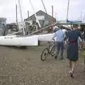 Ninja and Phil pish their bikes through a boatyard, A BSCC Splinter Group Camping Trip, Shottisham, Suffolk - 13th August 2004