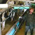 Wavy grabs a bunch of teat suckers, Wavy and the Milking Room, Dairy Farm, Thrandeston, Suffolk - 28th March 2005