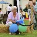 A woman with balloons waits for something to happen, The Village Fête, Yaxley, Suffolk - 18th June 2006