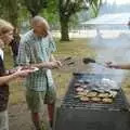 A burger is plucked from the fire, Qualcomm Cambridge "Go Ape", High Lodge, Thetford Forest - 27th July 2006