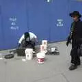 A woman walks past the street drummer, Crossing Brooklyn Bridge, New York, US - 26th March 2007