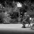 A street-dude sits and looks at a passing pigeon, Genesis Live at Parc Des Princes, Paris, France - 30th June 2007