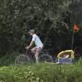 On the opposite side of the river, a dude cycles along the path, Qualcomm's Dragon-Boat Racing, Fen Ditton, Cambridge - 8th September 2007