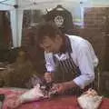 A butcher hacks away at a lamb leg, Harvest Festival at Jimmy's Farm, Wherstead, Suffolk - 12th September 2009