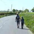 Isobel and Harry walk down the road, A Walk up Rapsy Tapsy Lane, Eye, Suffolk - 9th May 2020