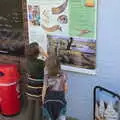 Fred and Harry read a sign, Camping on the Coast, East Runton, North Norfolk - 25th July 2020