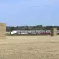 A Greater Anglia EMU behind stacks of bales, The Dragonfly Ride at Star Wing Brewery, Redgrave, Suffolk - 2nd September 2023