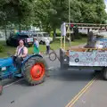 The Fordson tractor pulls out of the bus station, The Carnival Procession, Diss, Norfolk - 16th June 2024