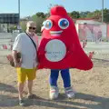 Hamish poses for a photo with the Olympic mascot, Hannah and Olympic ILCA 6 Sailing, Marseille, France - 5th August 2024