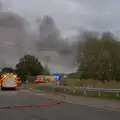 A hose snakes across the road, A Major Fire at Suffolk Highways, Brome, Suffolk - 15th September 2024