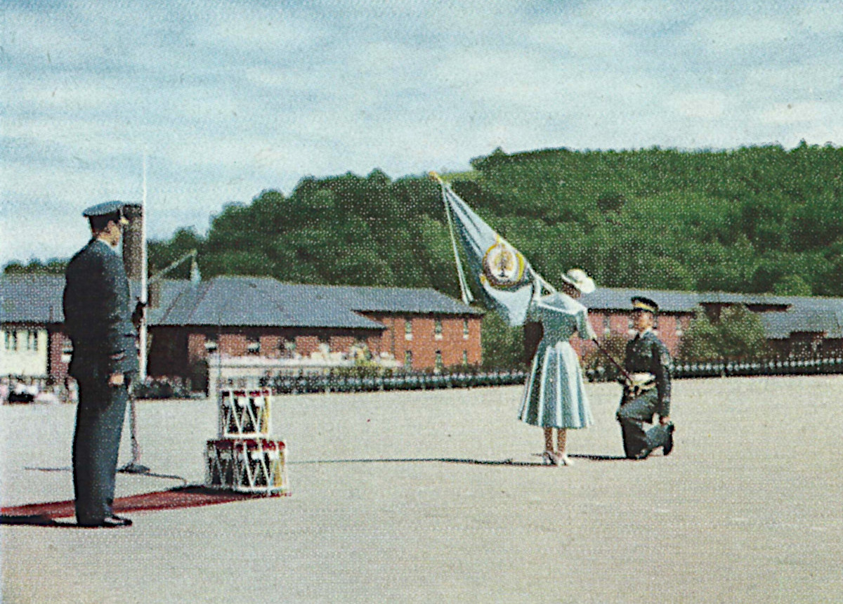 F. M. A. Hines receives the colour from the Queen