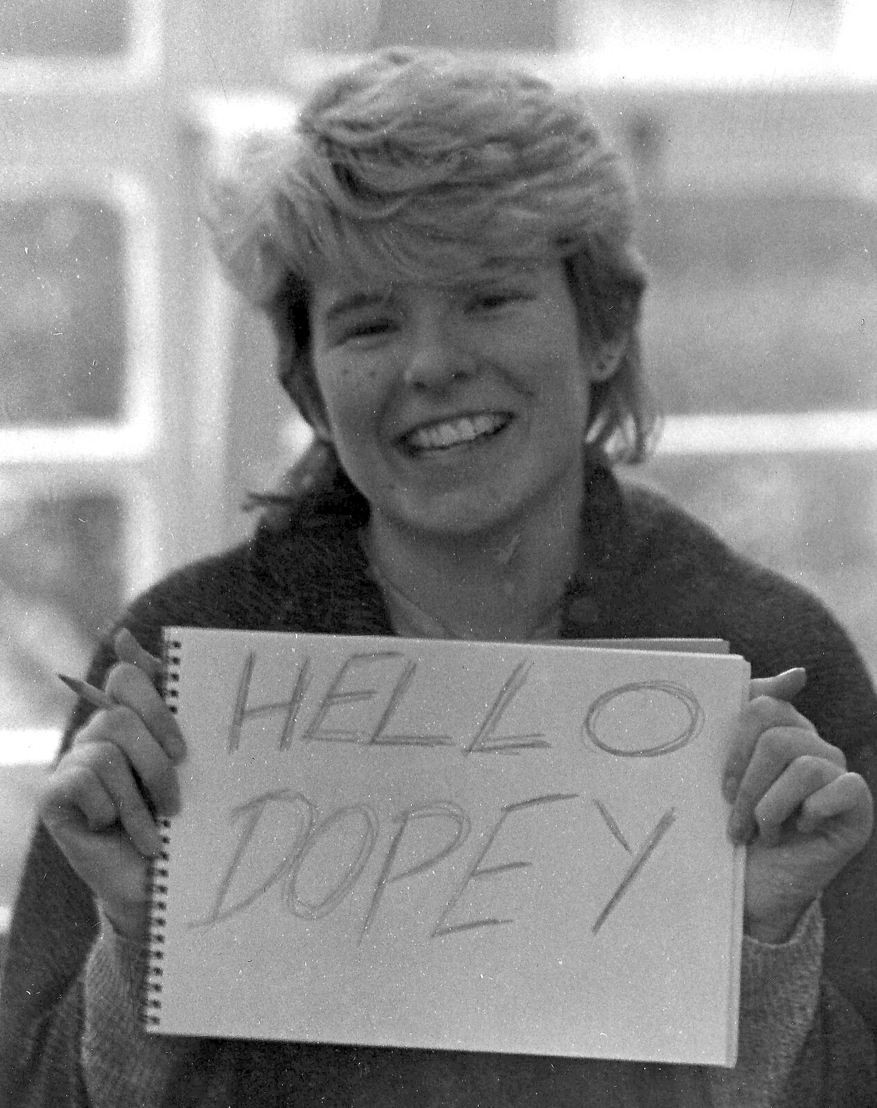 Jo holds up a 'hello Dopey' sign from Learning Black-and-White Photography, Brockenhurst College, Hampshire - 10th March 1985