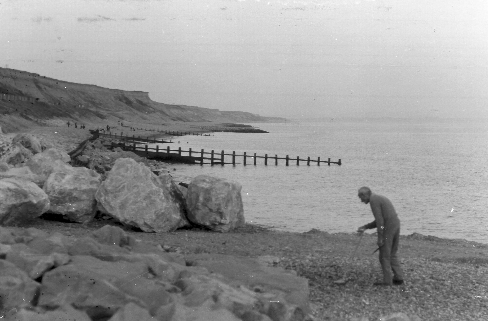 An old dude does metal detectoring on Barton beach from Life in Ford Cottage and Barton on Sea, Hampshire - 2nd April 1985