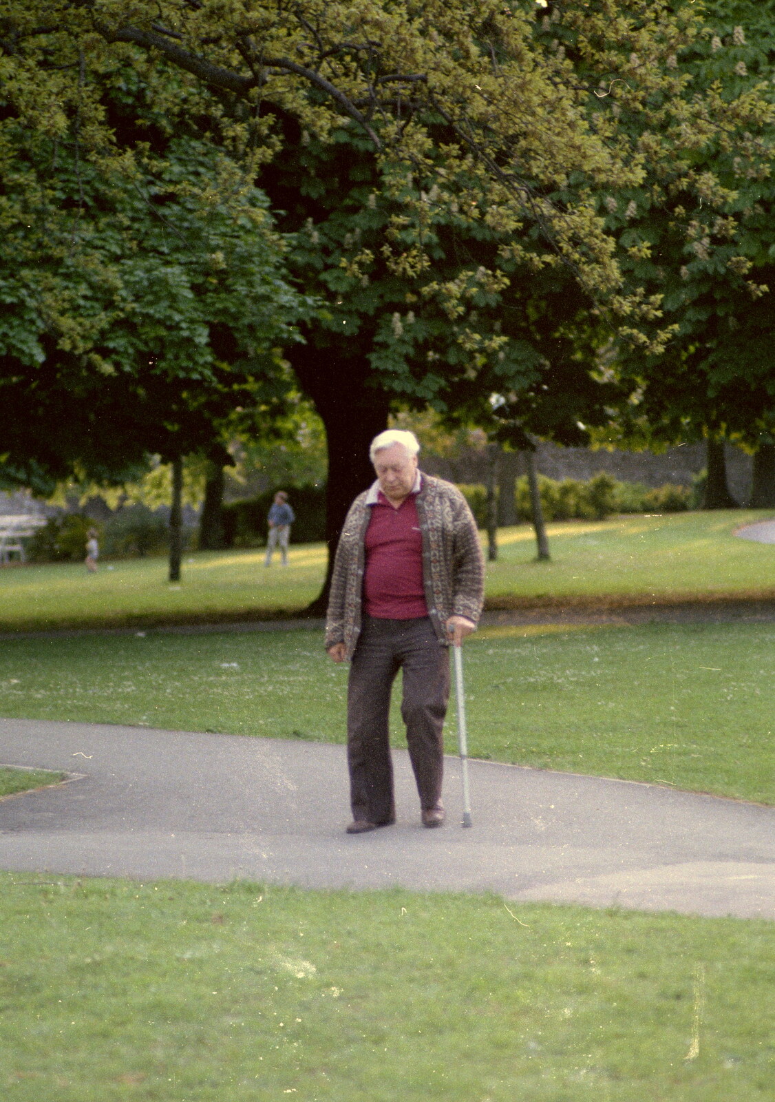Some old geezer roams around with a stick from Uni: A Central Park Fair and City Street Life, Plymouth - 20th October 1985