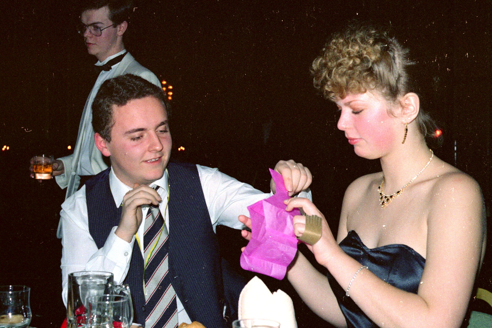 Andy Bray inspects a paper hat from Uni: BABS Christmas Ball and a Beaumont Street Party, Plymouth - 16th December 1985