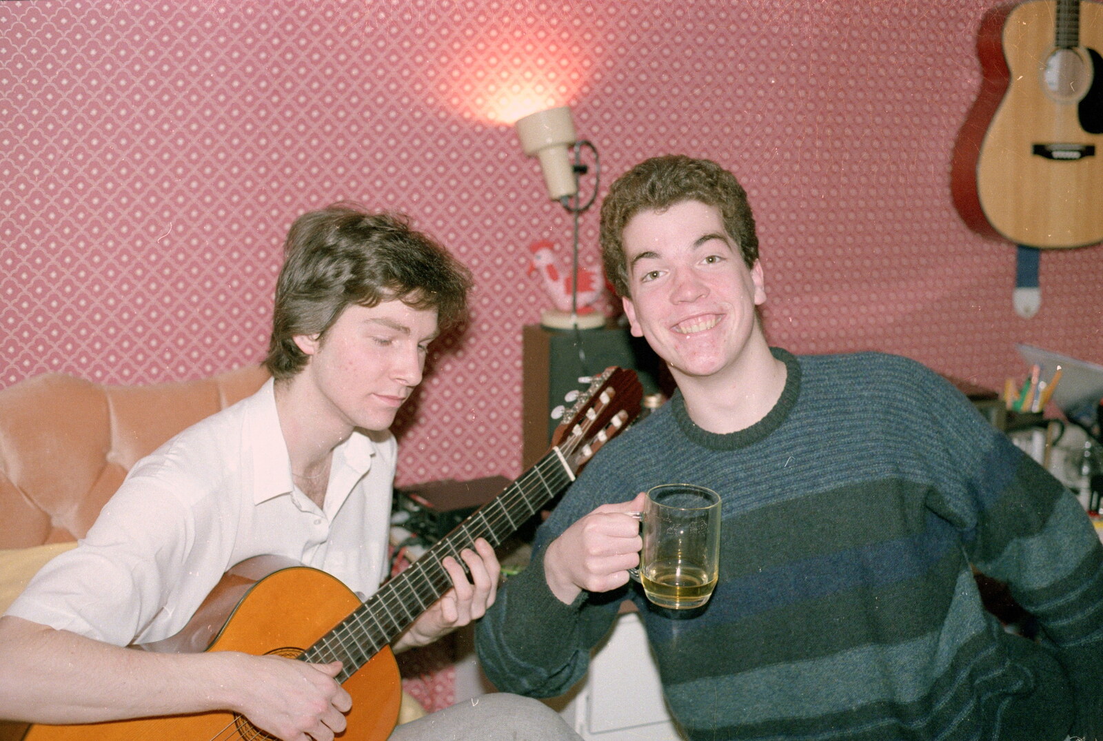 Sean plays guitar as Jon grins from Ford Cottage Pre-Christmas, Barton on Sea, Hampshire - 19th December 1985