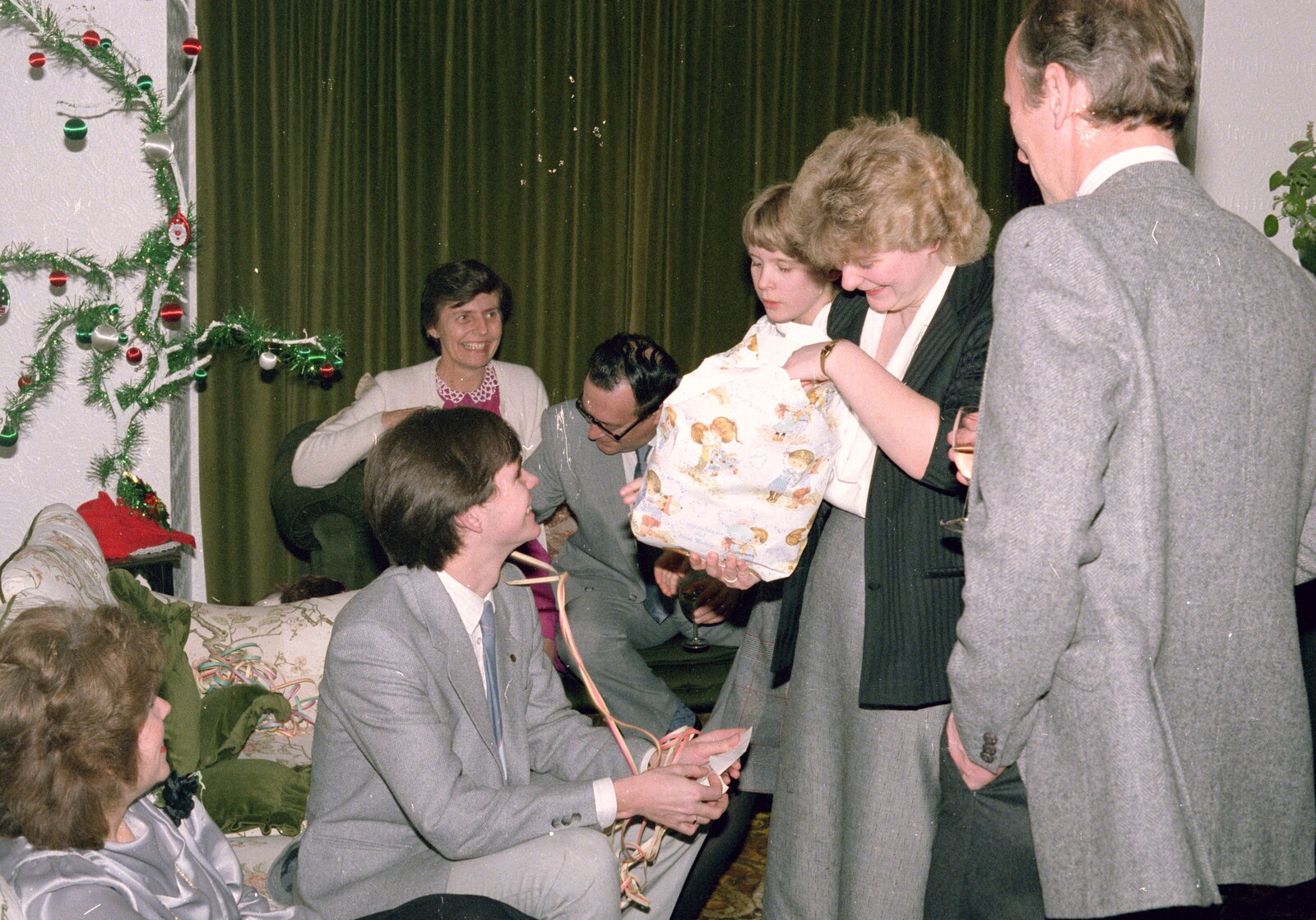 Anna opens a present, in a sea of grey suits from New Year's Eve at Anna's, Walkford, Dorset - 31st December 1985