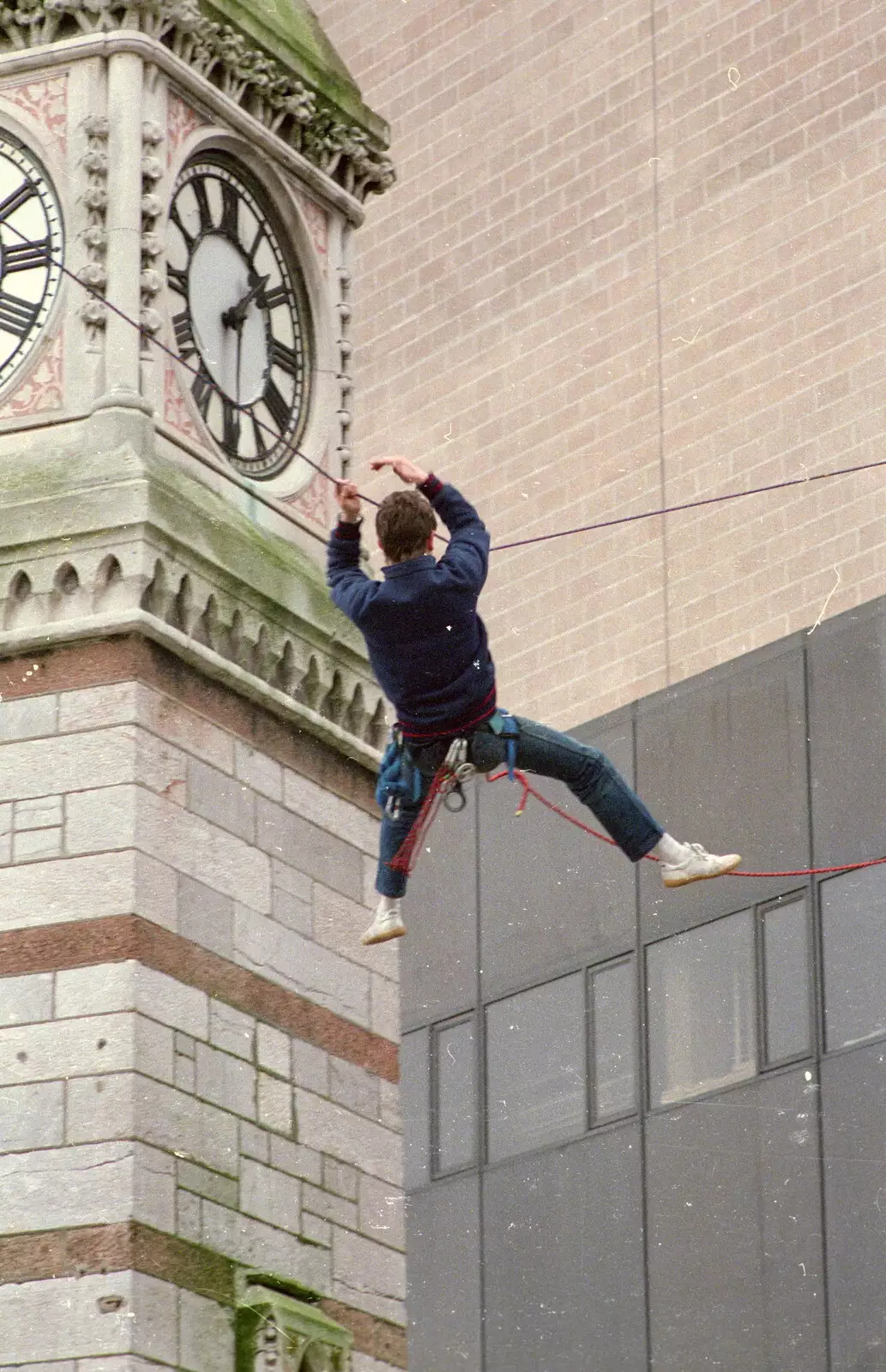 An abseiler hangs around near the clock tower, from Uni: RAG Week Abseil, Hitch Hike, and Beaumont Street Life Plymouth, Devon - 13th February 1986