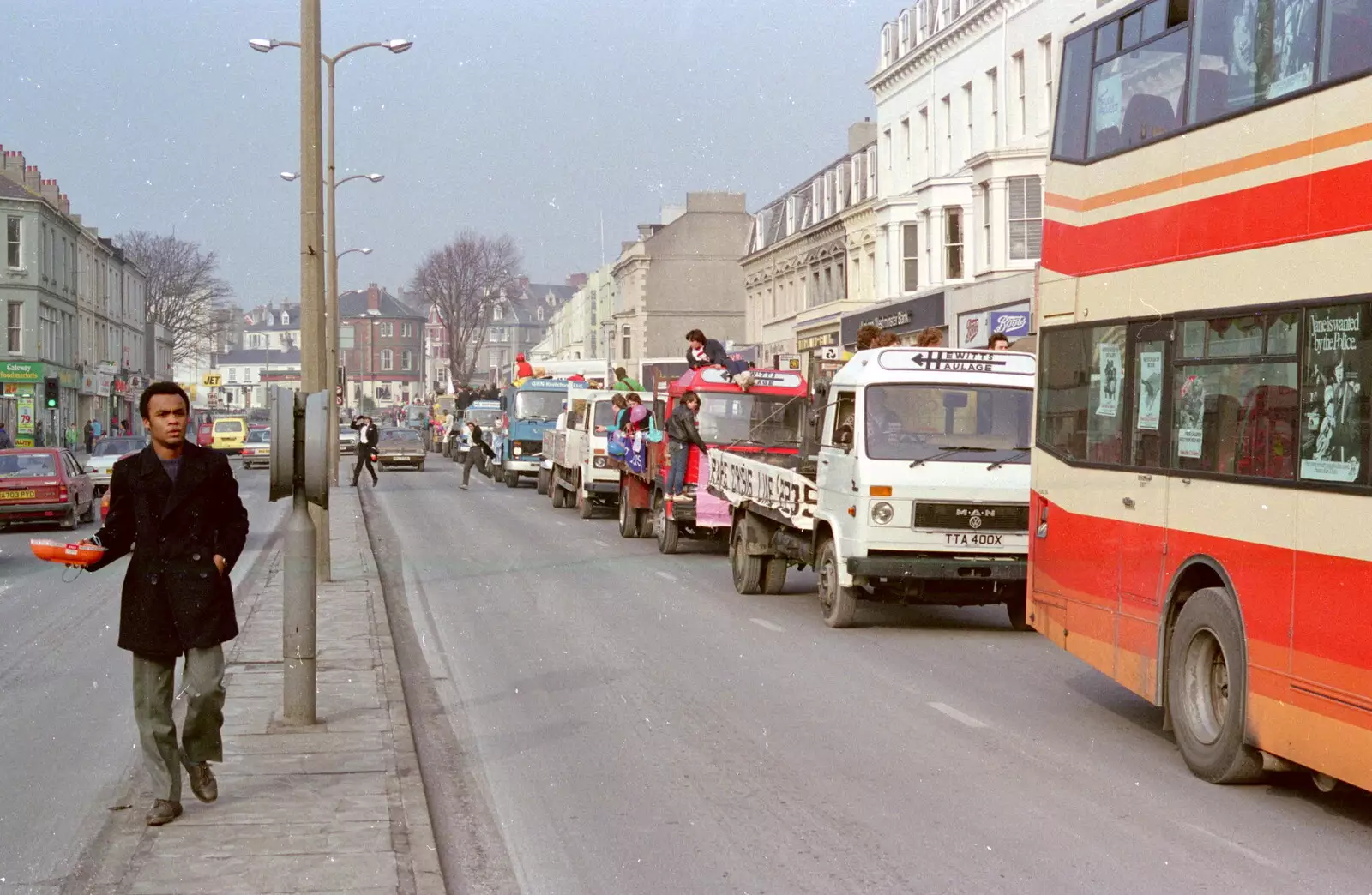 Simon Bento on the central resevation on Mutley Plain, from Uni: PPSU "Jazz" RAG Street Parade, Plymouth, Devon - 17th February 1986