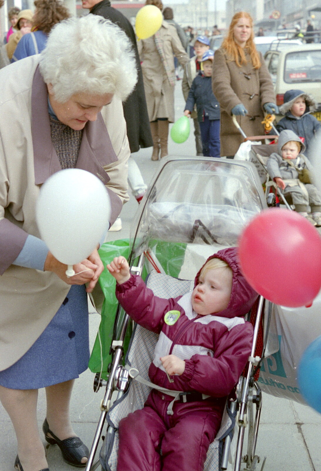 A sprog gets a balloon from Uni: PPSU "Jazz" RAG Street Parade, Plymouth, Devon - 17th February 1986