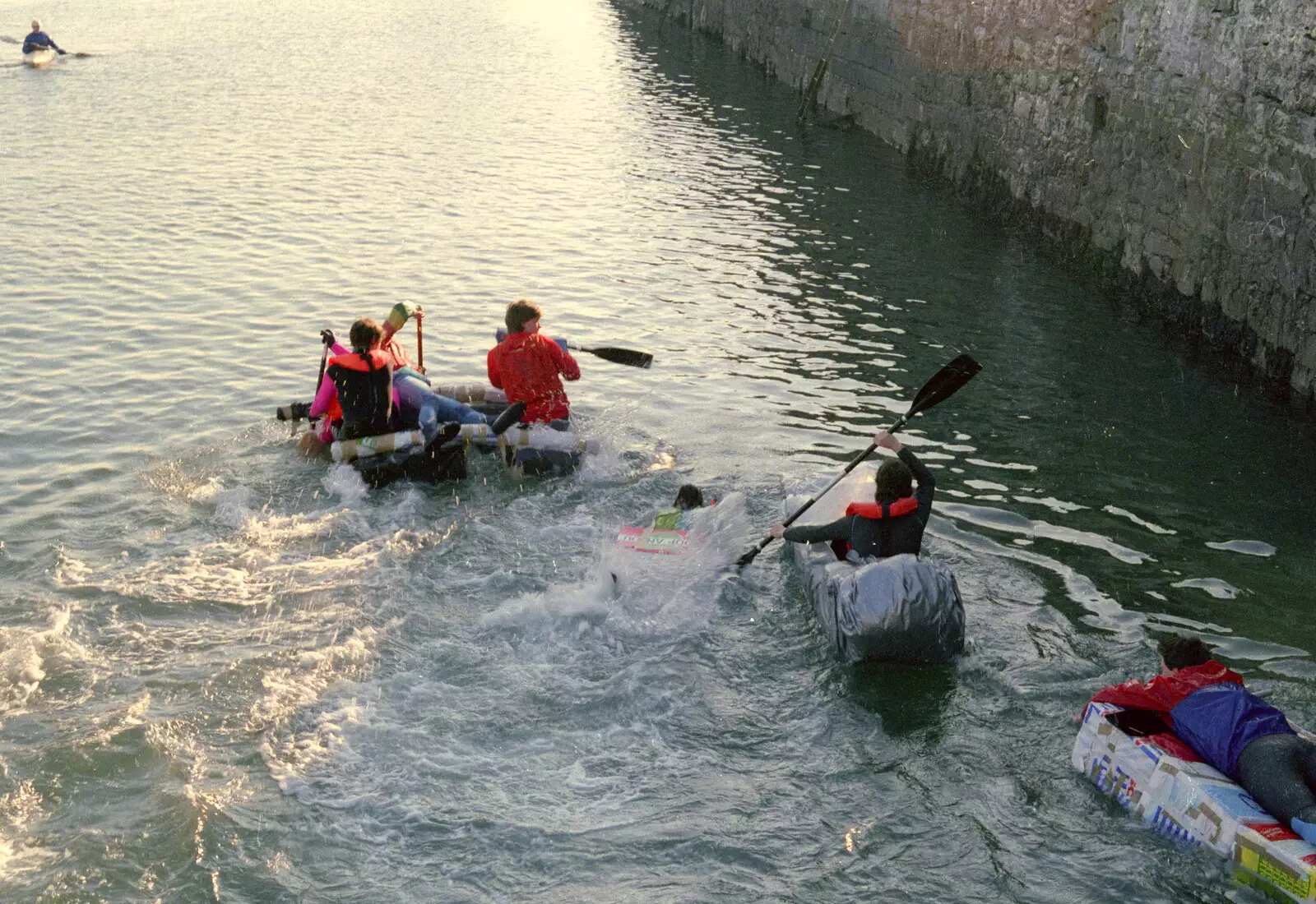 Intrepid rafters head down the slipway at the Yacht club, from Uni: Canoe Society RAG Raft Madness, Plymouth Sound - 1st March 1986