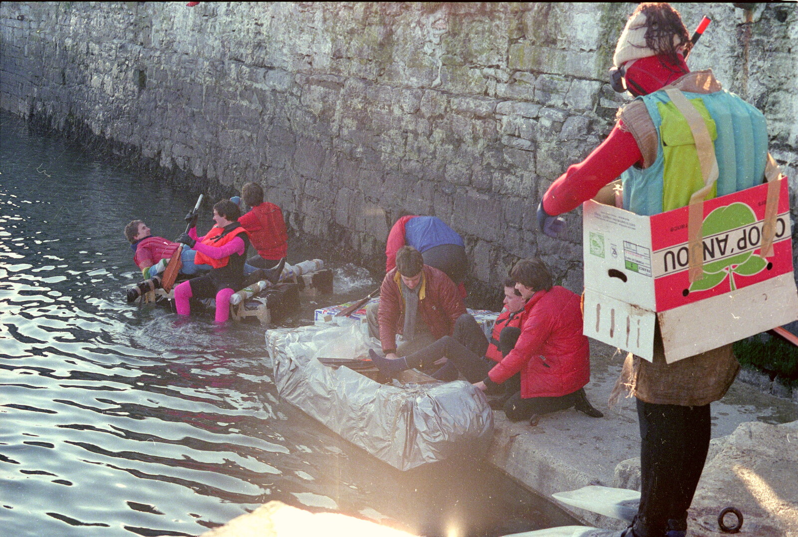 A particular brave entry equipped with nothing more than a cardboard box from Uni: Canoe Society RAG Raft Madness, Plymouth Sound - 1st March 1986