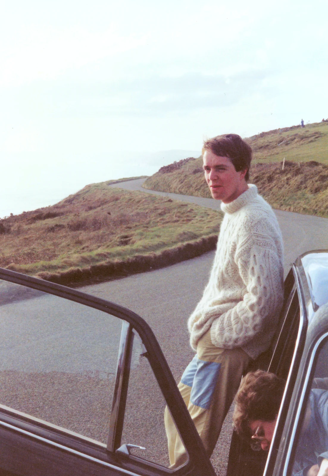 Malcolm leans on Barbara's car, from Uni: The End of Term and Whitsand Bay, Plymouth and New Milton - 21st March 1986