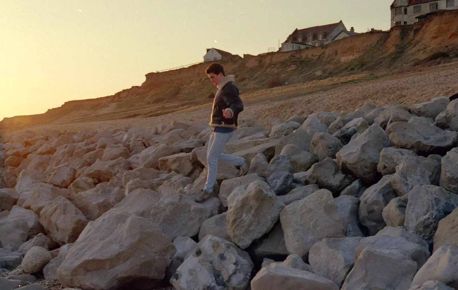 Jon the Hair climbs down the rocks, from A CB Reunion and a Trip to the Beach, Barton on Sea, Hampshire - 4th April 1986