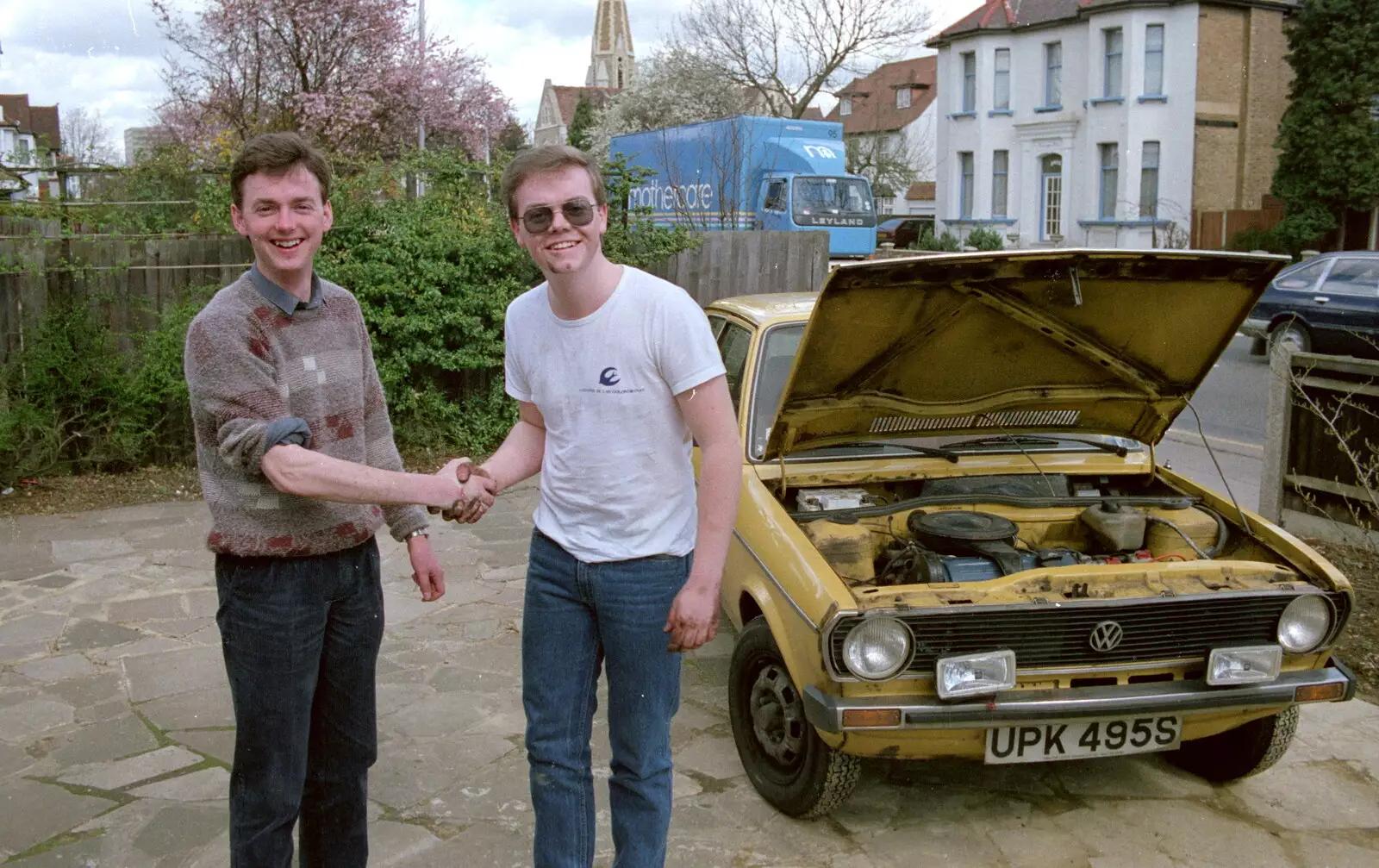 John and Dave shake hands after a successful repair, from Trotsky's Birthday, New Malden, Kingston Upon Thames - 20th April 1986