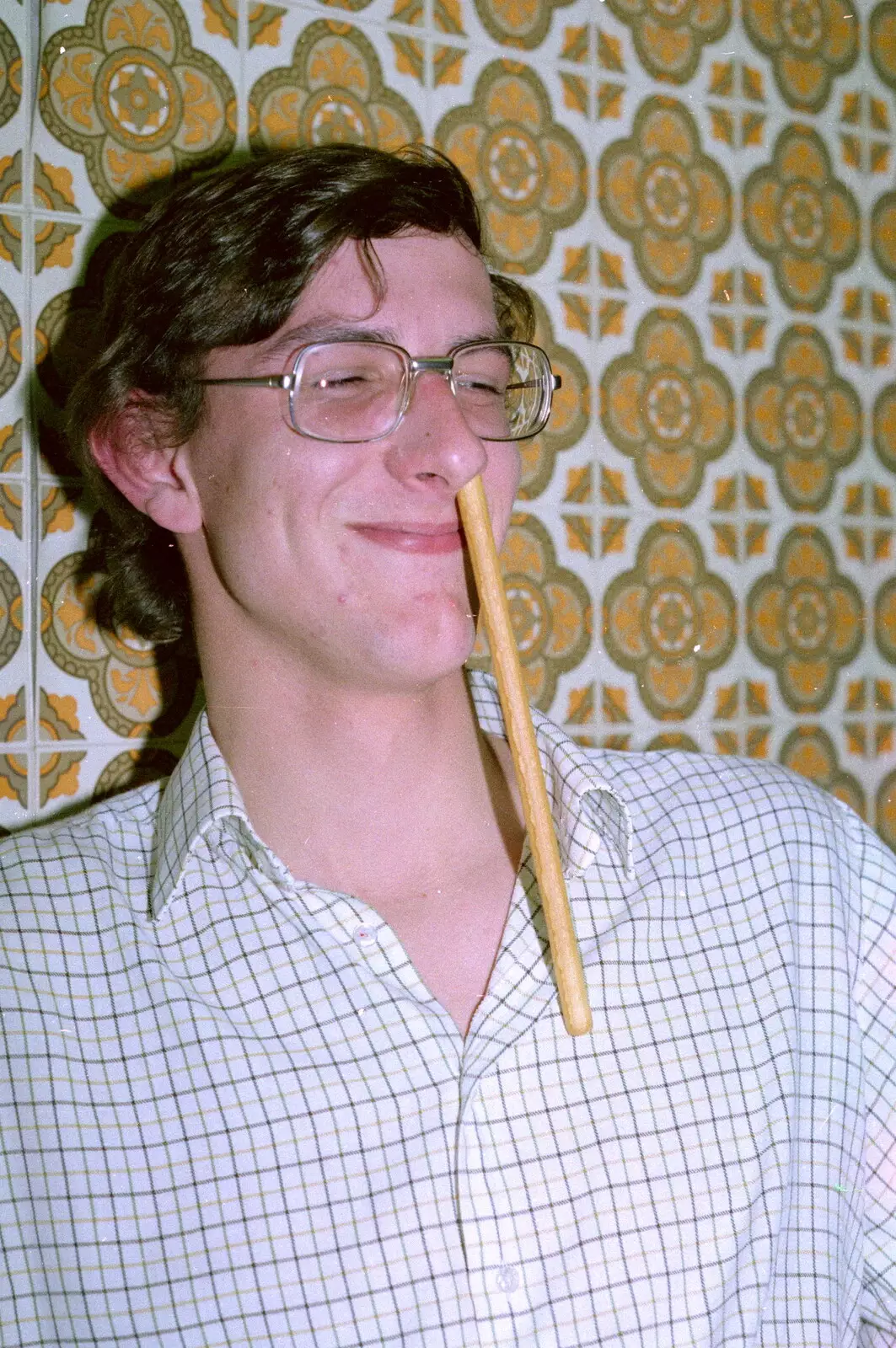 Andy sticks a breadstick up his nose, from Uni: A Breadsticks Dinner Party and a Night in PPSU, Cromwell Road, Plymouth - 28th April 1986