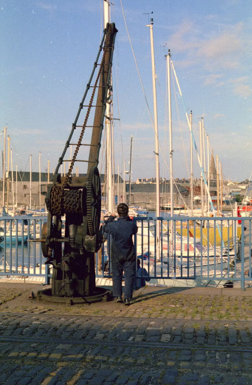 Someone pauses by an old crane, from Uni: Scenes of Plymouth and the PPSU Bar, Plymouth Polytechnic, Devon - 28th April 1986