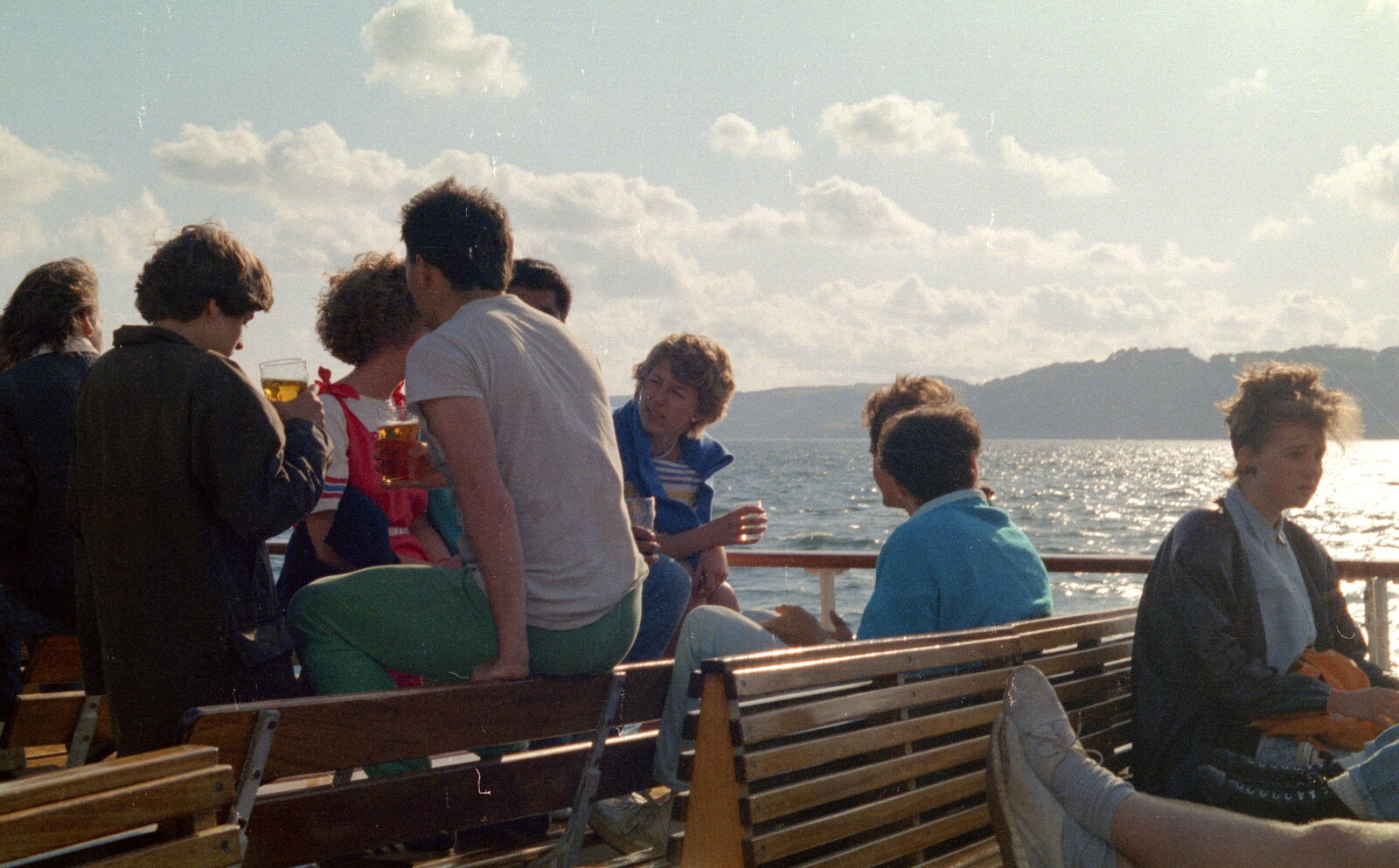 Students on benches from Uni: A Student Booze Cruise, Plymouth Sound, Devon - 2nd May 1986