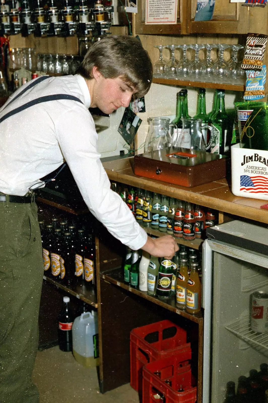 A bottle of Satique is selected by the barman, from Uni: The Plymouth Polytechnic Satique Project, Salcombe and Plymouth - 10th May 1986