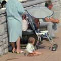 A baby sits on the pavement, Uni: Phil and Anna Visit Nosher, Plymouth, Devon - 18th May 1986