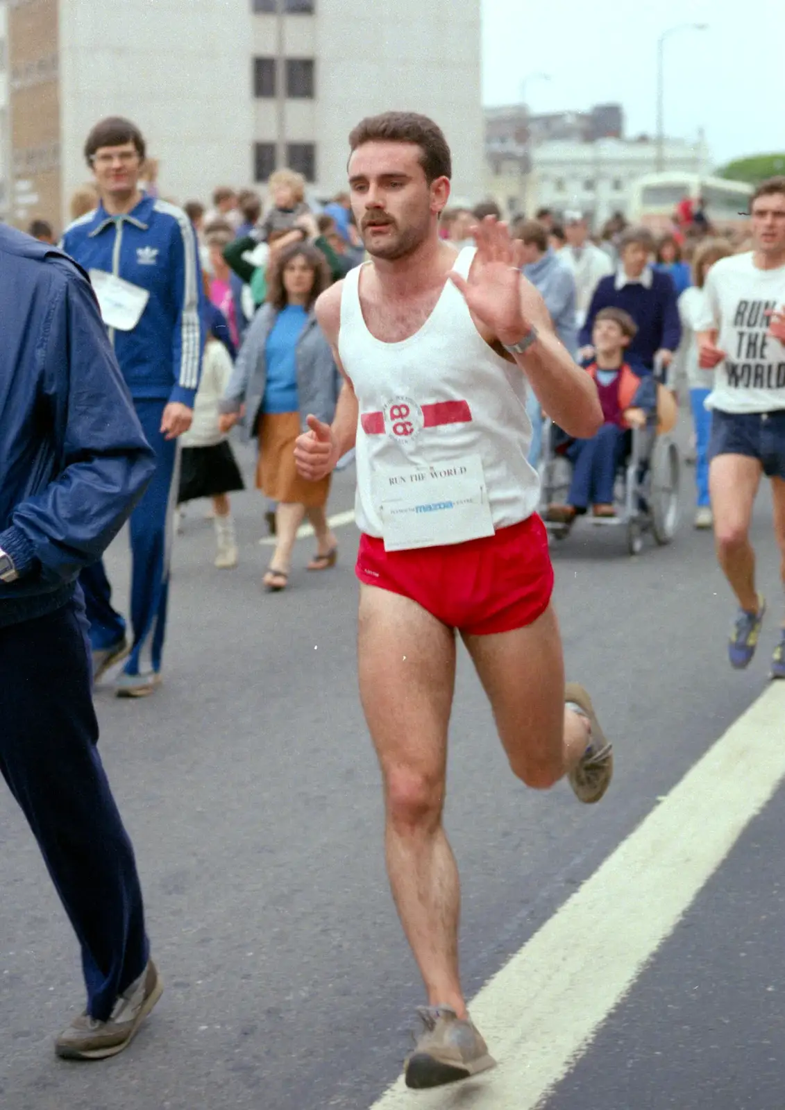 Mark, off of Phsychology, waves on his way round, from Uni: Sport Aid - Run The World, Plymouth, Devon - 25th May 1986