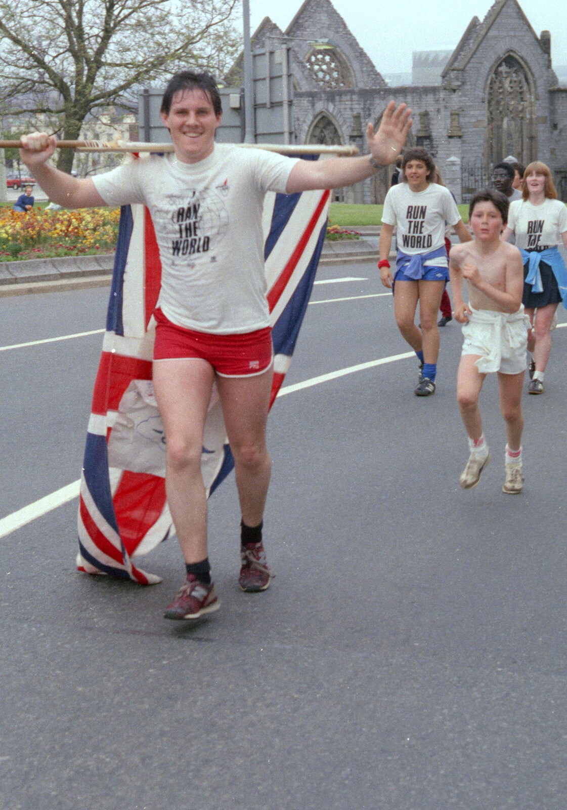A runner hauls around a Union Flag from Uni: Sport Aid - Run The World, Plymouth, Devon - 25th May 1986