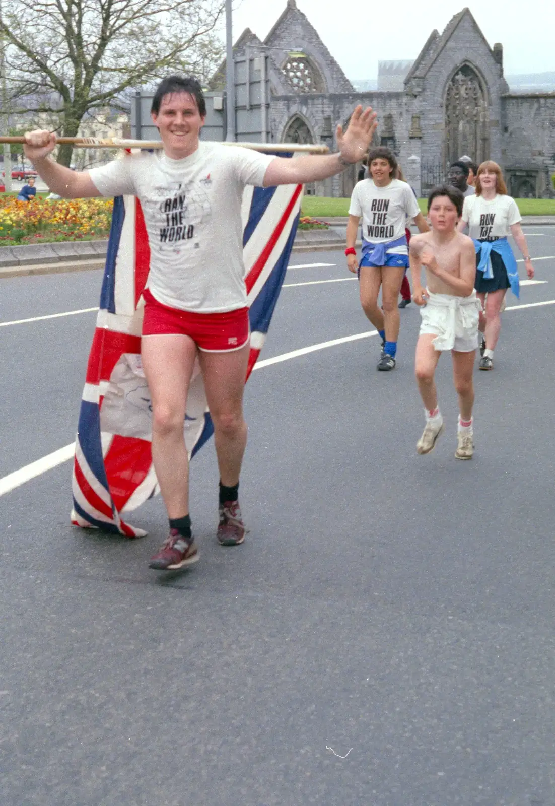 A runner hauls around a Union Flag, from Uni: Sport Aid - Run The World, Plymouth, Devon - 25th May 1986