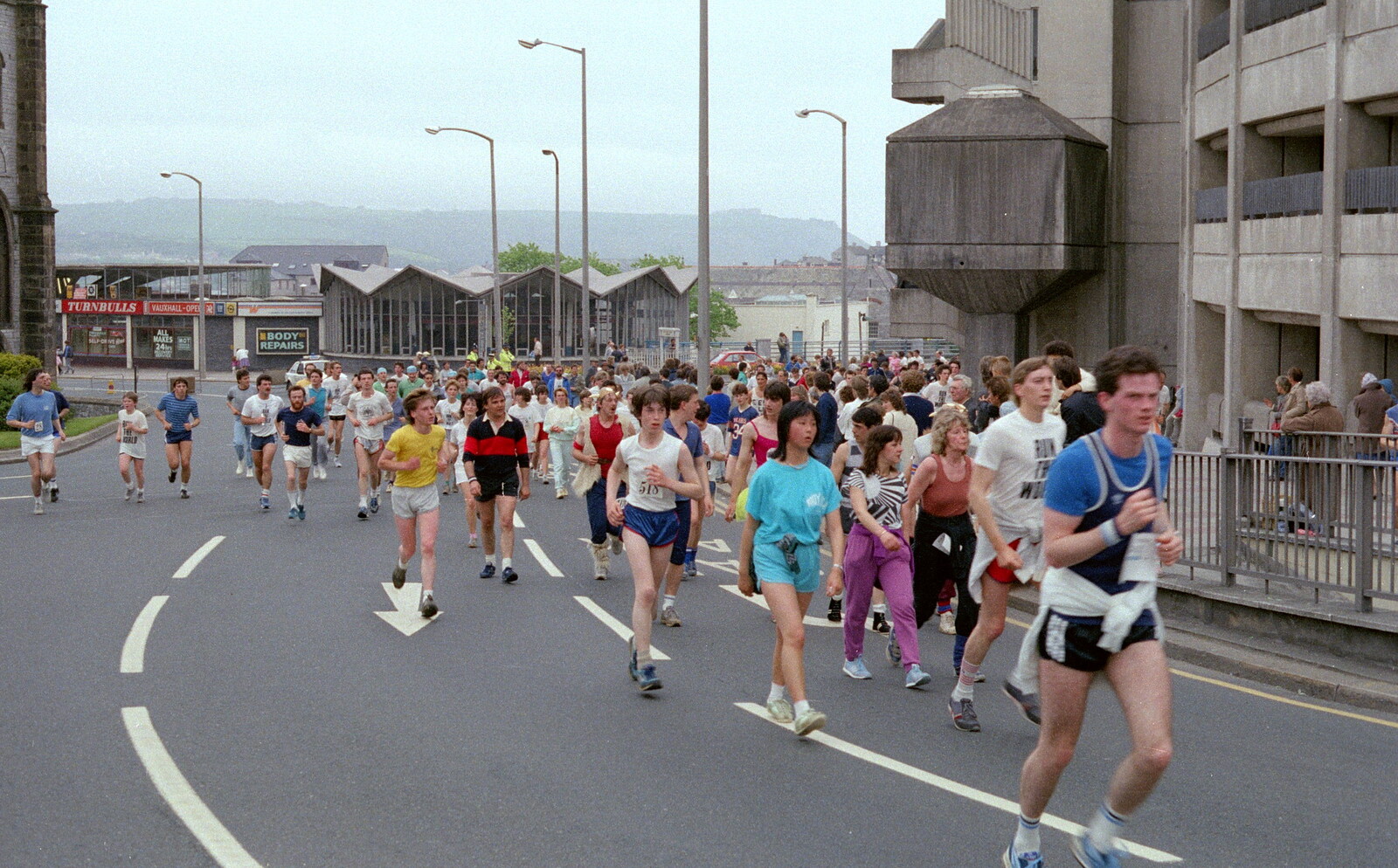 A crowd of runners come up from Charles Cross from Uni: Sport Aid - Run The World, Plymouth, Devon - 25th May 1986